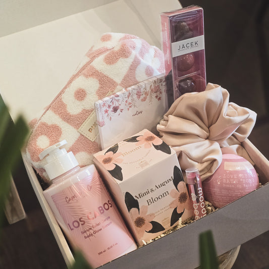 Gift box with beauty products including a bath bomb, soap, and lotion. Valentine' Day gift box